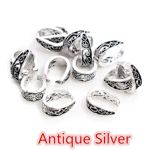 Close-up of antique silver alloy pendant bails with vintage baroque embossed patterns