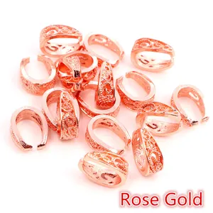 Macro detail of rose gold filigree pinch bails for vintage style jewelry making