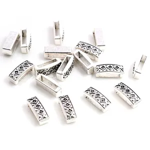 Macro view of vintage silver alloy slider beads with geometric tribal patterns for DIY bracelets