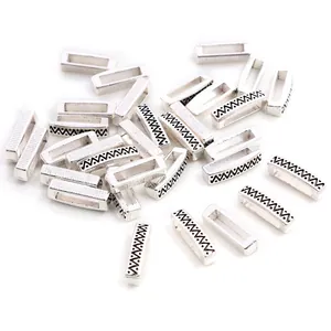Close-up of silver rectangular spacer beads with wave texture for DIY jewelry making