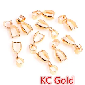 Close-up of KC gold copper pendant pinch bails and jewelry connectors for DIY making
