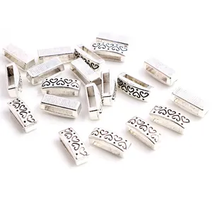 Close-up of silver rectangle slider beads with heart pattern for leather bracelets