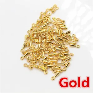 Close-up of golden teardrop metal pendants for DIY jewelry making accessories
