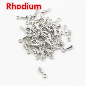 Macro detail of 7x3mm rhodium-plated metal drop charms for DIY jewelry making