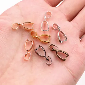 Copper pendant bail connectors in five metallic colors held in hand for size comparison