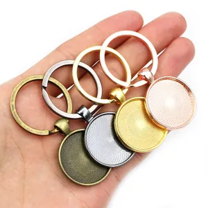DIY metal keychain ring base set in multiple metallic colors held by hand