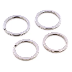 Close-up of four flat silver stainless steel key rings with a spiral metal structure