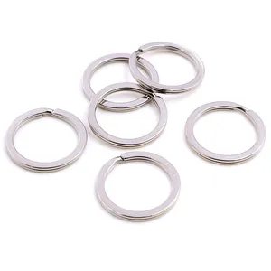 Close-up of six polished stainless steel split key rings on a white background