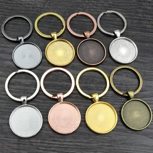 Macro shot of assorted DIY keychain bezels with mandala patterns on dark wood background