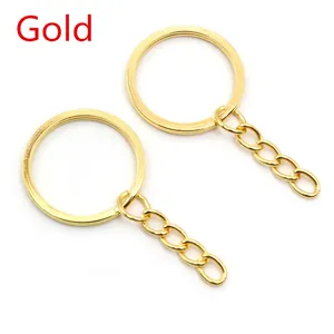 Detailed view of polished gold metal key rings with 4-link chain connectors on white background