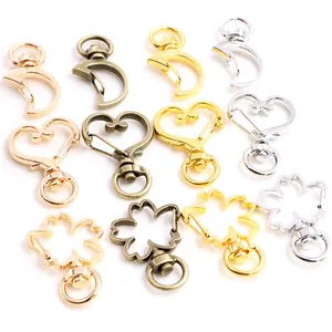 Detailed macro view of heart, moon, and flower shaped alloy lobster clasps in various colors