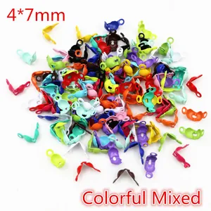Macro detail of 4x7mm colorful mixed metal fold-over crimp beads for DIY jewelry making