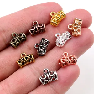 DIY jewelry connector set in multiple metallic finishes shown on a fingertip for scale
