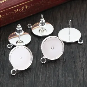 Silver plated earring posts with hanging loops and butterfly backs on a wood background