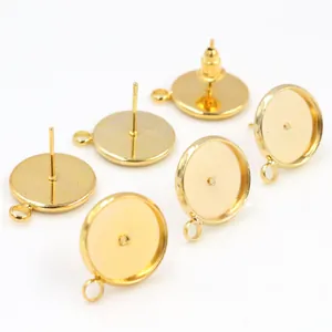 Macro view of gold-plated earring posts with bezel settings and hanging loops for DIY jewelry