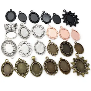 Oval alloy pendant trays in antique silver and gold finishes for DIY jewelry making