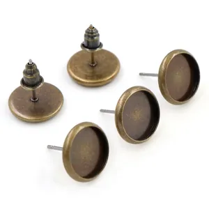 Macro detail of antique bronze earring studs with round blank tray bases for DIY jewelry