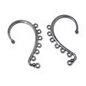 Detailed macro view of gunmetal hair stick accessory with seven small hanging loops