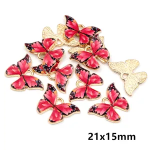 Macro view of 21x15mm red floral butterfly charms with gold alloy edges for DIY jewelry