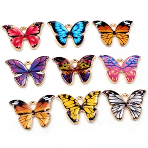 Set of nine colorful enamel butterfly pendants with golden alloy edges for DIY jewelry making