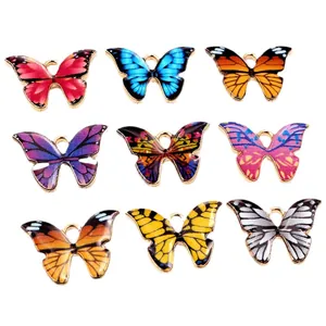 Set of nine colorful enamel butterfly pendants with gold metal edges for DIY jewelry