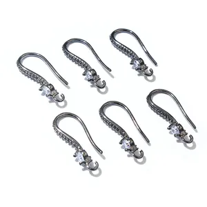 Macro view of six gunmetal black earring hooks with sparkling zircon stones and loops