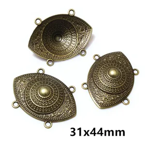 Macro view of 31x44mm antique bronze multi-hole connectors with embossed flower pattern