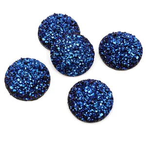 Macro shot of 5 cobalt blue druzy resin cabochons with sparkling crystal texture