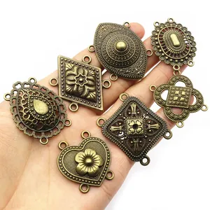 Antique bronze ethnic style multi-hole jewelry connectors held in palm for DIY jewelry making