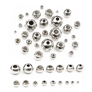 Detailed macro view of various sizes of polished stainless steel spacer beads for DIY jewelry