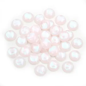 Close-up of 12mm pink iridescent resin cabochons with pearlescent finish for DIY jewelry