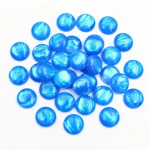 Close-up of 12mm royal blue glitter resin round dome cabochons for DIY jewelry making