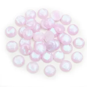 Close-up of 12mm iridescent light pink resin cabochons for DIY jewelry making