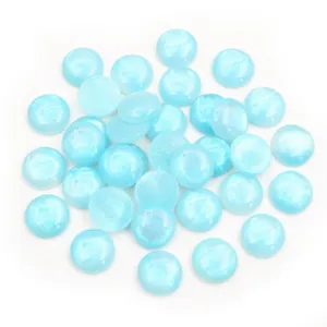 Close-up of sky blue 12mm round resin cabochons with sparkling glitter texture for DIY crafts
