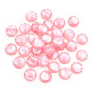 Macro detail of 12mm pink resin flatback cabochons with pearl luster for DIY jewelry making