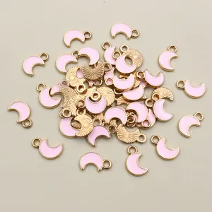 Macro view showing bulk pink moon alloy charms with golden plating for DIY jewelry