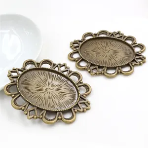 Macro shot of 30x40mm oval bronze alloy pendant base with vintage sunburst texture