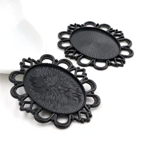 Detail showing two black oval cabochon settings with hollow lace edges for DIY jewelry