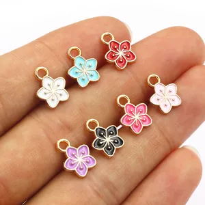 Set of seven colorful enamel flower pendants in gold alloy for DIY jewelry making