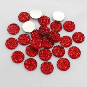 Macro detail of 12mm red pineapple facet resin rhinestones with flat silver backs