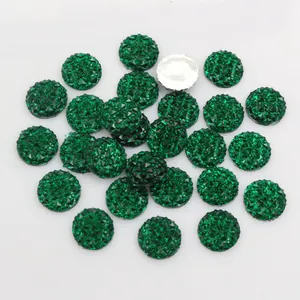Macro detail of 12mm green resin round faceted pineapple cut cabochons with silver flat back