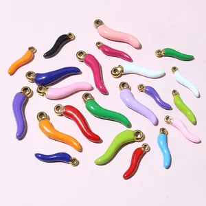 Detailed top view of colorful enamel chili pendants with gold rings for DIY jewelry