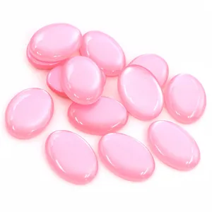 Macro detail of oval pink resin stones with cat eye effect for DIY jewelry making