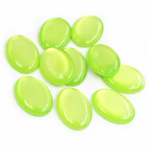 Macro shot of transparent light green oval resin cabochons with smooth polished finish