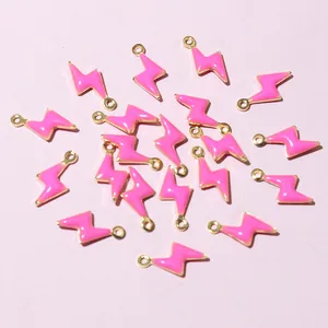 Macro shot of 20 pink enamel lightning bolt charms with gold trim for DIY jewelry