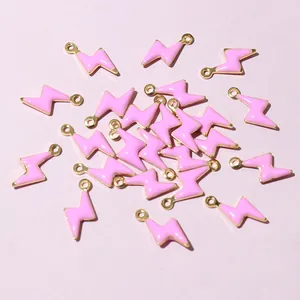 Detailed view of pink enamel lightning bolt charms for DIY jewelry making and crafts
