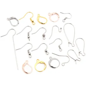 Detailed macro view of assorted stainless steel DIY earring hooks in gold and silver finishes
