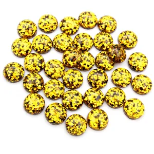 Nahaufnahme der runden Harz-Cabochons mit goldenen Glitzerflocken für DIY-Schmuck