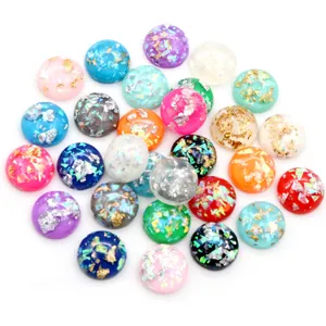 Close-up of assorted round resin beads with embedded silver foil for DIY jewelry making