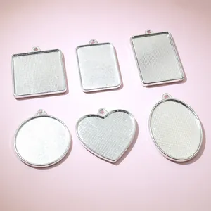 Set of six silver alloy pendant trays in heart, oval, and square shapes for DIY jewelry